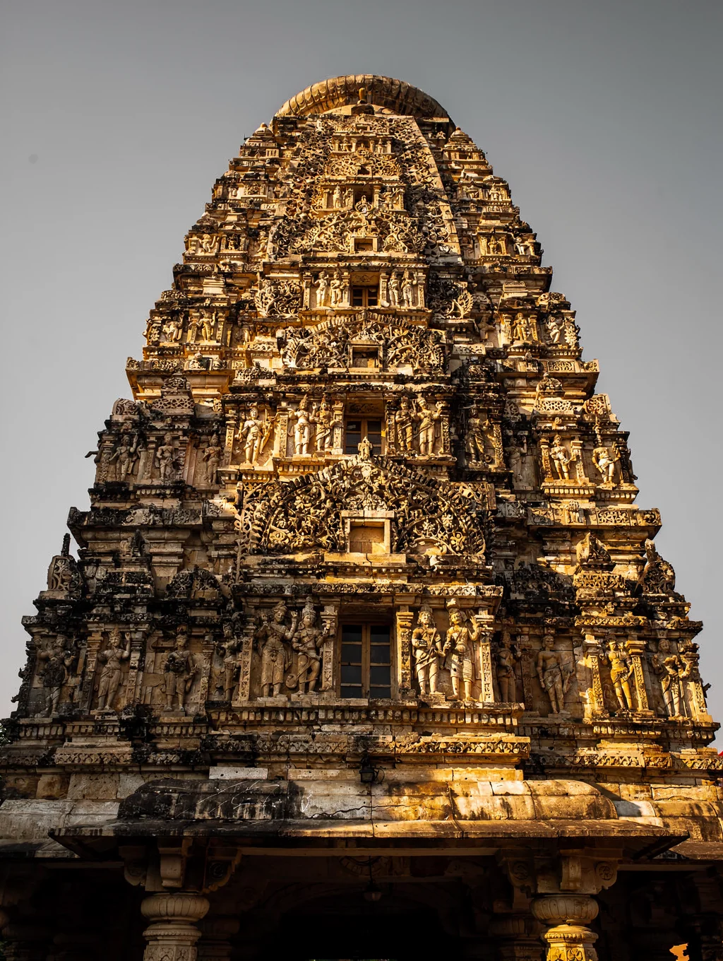 Ancient stone temple shikhara bathed in peaceful golden hour sunlight